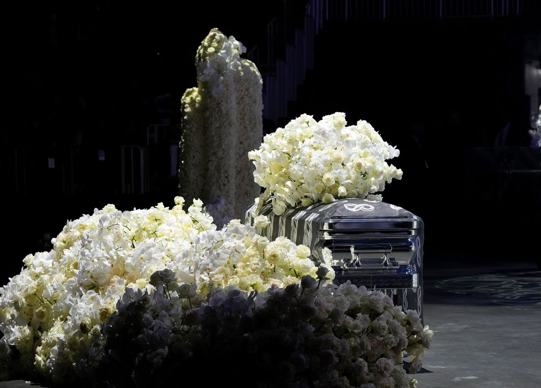 Takeoff's flower-covered casket sits at the foot of the stage during the service.