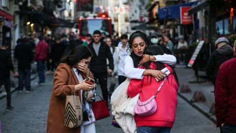 People hug each other at the site of the explosion. 