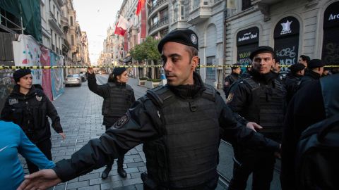 Police officers secure the area after the explosion.