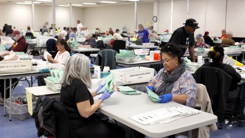 Election workers open mail in ballots at the Maricopa County Tabulation and Election Center on November 11, 2022, in Phoenix.