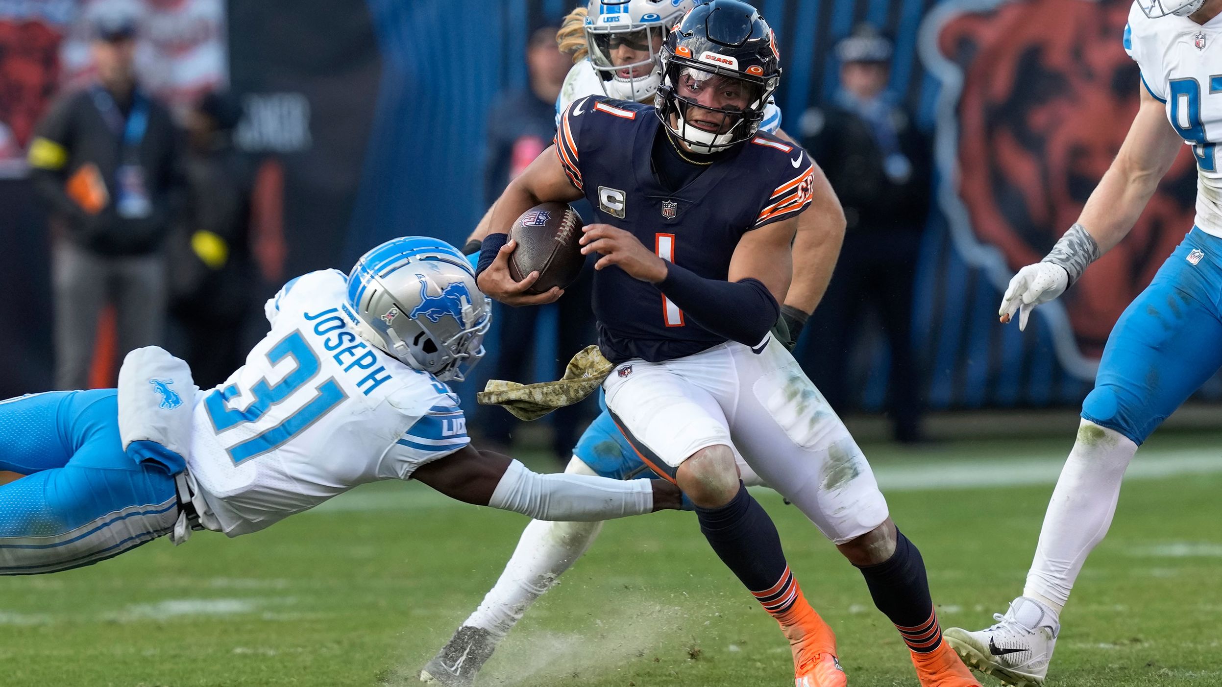 Chicago Bears quarterback Justin Fields evades Detroit Lions safety Kerby Joseph as he runs for a 67-yard touchdown. Fields ran for 147 yards and two touchdowns, but it wasn't enough as the Bears lost 31-30 to the Lions.