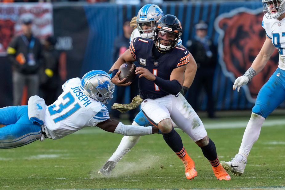 Chicago Bears quarterback Justin Fields evades Detroit Lions safety Kerby Joseph as he runs for a 67-yard touchdown. Fields ran for 147 yards and two touchdowns, but it wasn't enough as the Bears lost 31-30 to the Lions.