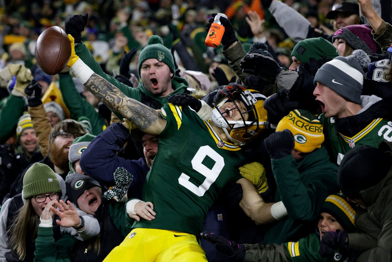 Green Bay Packers wide receiver Christian Watson celebrates with fans after scoring a touchdown during the second half against the Dallas Cowboys. The rookie caught three touchdowns as the Packers ended a five-game losing streak to beat the Cowboys 31-28 in overtime.
