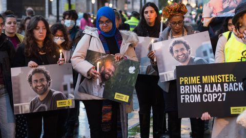 Supporters of Alaa Abd El-Fattah take part in a candlelight vigil outside Downing Street in London on November 6.