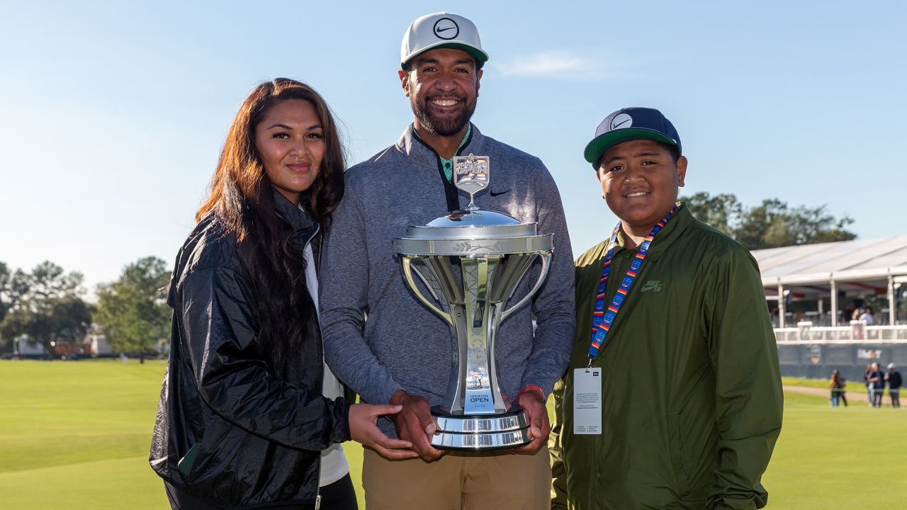 Finau poses with the Houston Open trophy alongside his family.