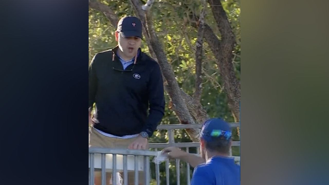 Pádraig Harrington hands money to a fan to buy beers at the Charles Schwab Cup Championship on Sunday.
