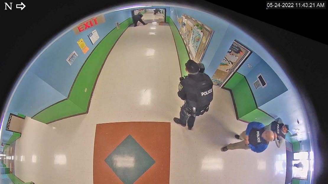 Pargas, to the right in a blue shirt, entered the hallway at 11:36 a.m.