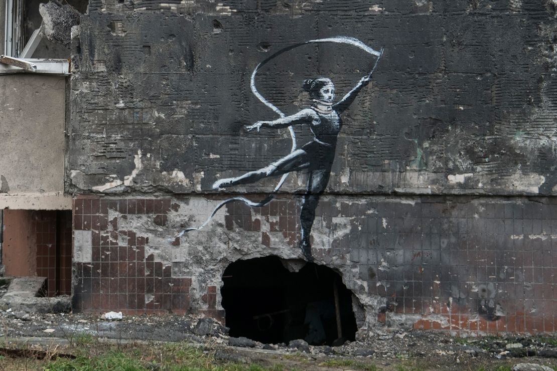 Wearing a neck brace, a rhythmic gymnast performs in a new Banksy piece painted on the wall of a residental building in Irpin, Ukraine.
