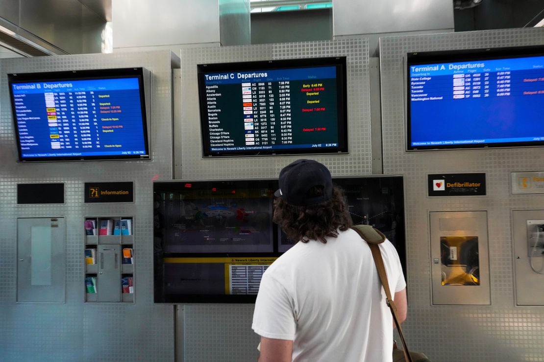 Flight information is displayed at Newark Liberty International Airport on July 3, 2022. Hundreds of flights were canceled across the US ahead of July Fourth weekend.