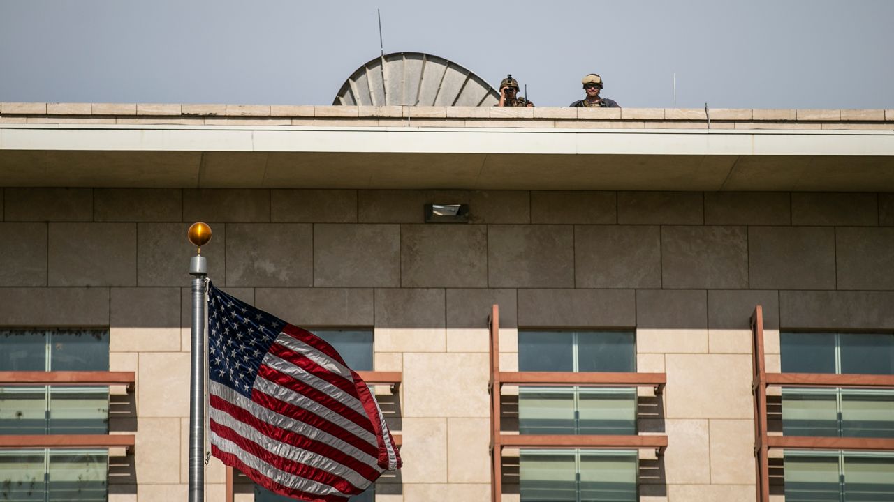 US soldiers stand guard on the roof of the US Embassy as they watch a protest to reject an international military force requested by the government and to demand the resignation of Prime Minister Ariel Henry, in Port-au-Prince, Haiti, Monday, Oct. 17, 2022. 