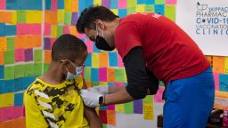 Dr. Mayank Amin puts a band-aid on 10-year-old Ernest "EJ" Jones after administering a Pfizer-BioNTech coronavirus disease (COVID-19) booster vaccine at Skippack Pharmacy in Schwenksville, Pennsylvania, U.S., May 19, 2022. REUTERS/Hannah Beier