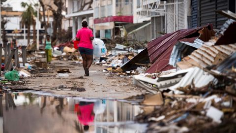 A woman walks on a street in Saint-Martin on September 11, 2017, after Hurricane Irma.