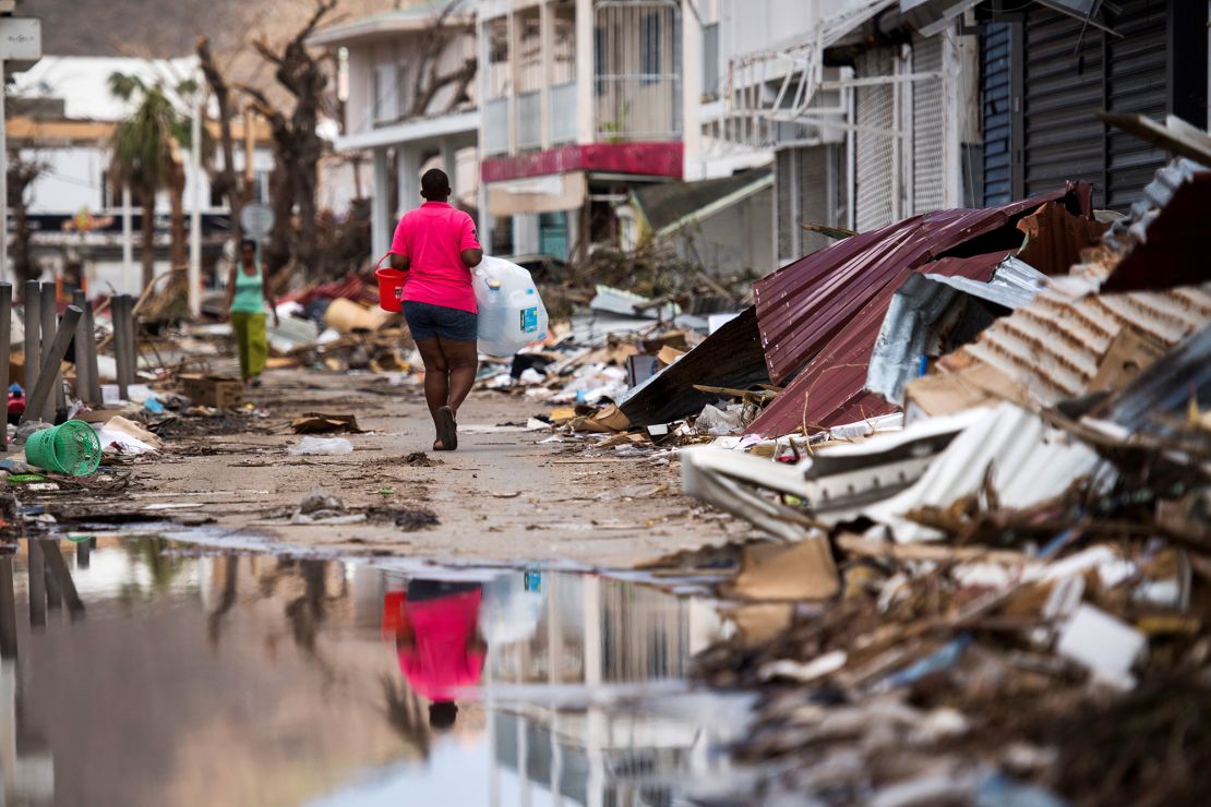 A woman walks on a street in Saint-Martin on September 11, 2017, after Hurricane Irma.