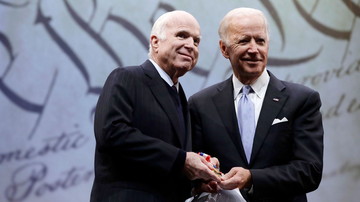 Then-Sen. John McCain of Arizona receives the Liberty Medal from Chair of the National Constitution Center's Board of Trustees, former Vice President Joe Biden, in Philadelphia, on October 16, 2017. 