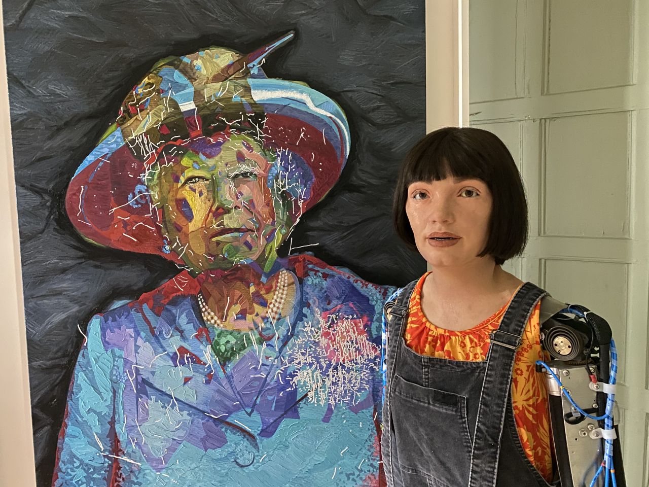 In 2019, scientists at the University of Oxford introduced Ai-Da, a humanoid robot that uses AI to write poetry and create paintings and sculptures. Pictured, Ai-Da poses with a portrait it made of Queen Elizabeth II.