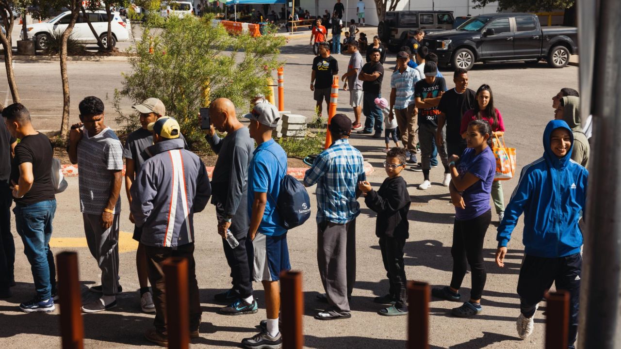 Migrants wait on September 19, 2022, outside the Migrant Resource Center in San Antonio, Texas, the place of origin of the two planeloads of mostly Venezuelan migrants who were sent to Martha's Vineyard, Massachusetts, by Florida Gov. Ron DeSantis. 