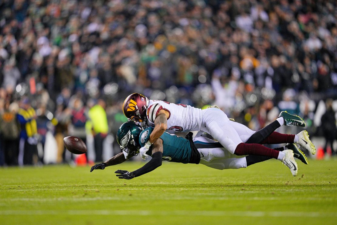 Commanders cornerback Benjamin St-Juste knocks the ball from Eagles wide receiver Quez Watkins.