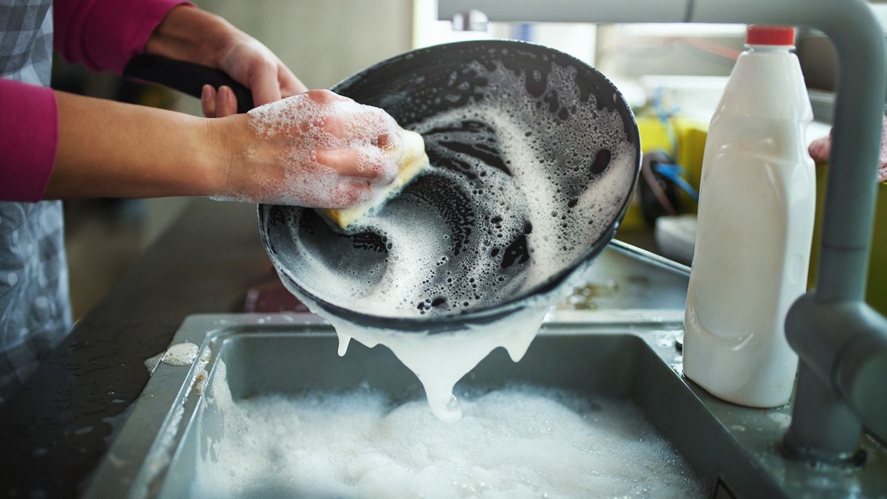 Washing dishes with a limited amount of water — instead of a running tap — is one way to reduce water use at home. 