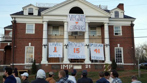 A memorial honoring Devin Chandler, Lavel Davis Jr. and D'Sean Perry features signs with the football players' jersey numbers.