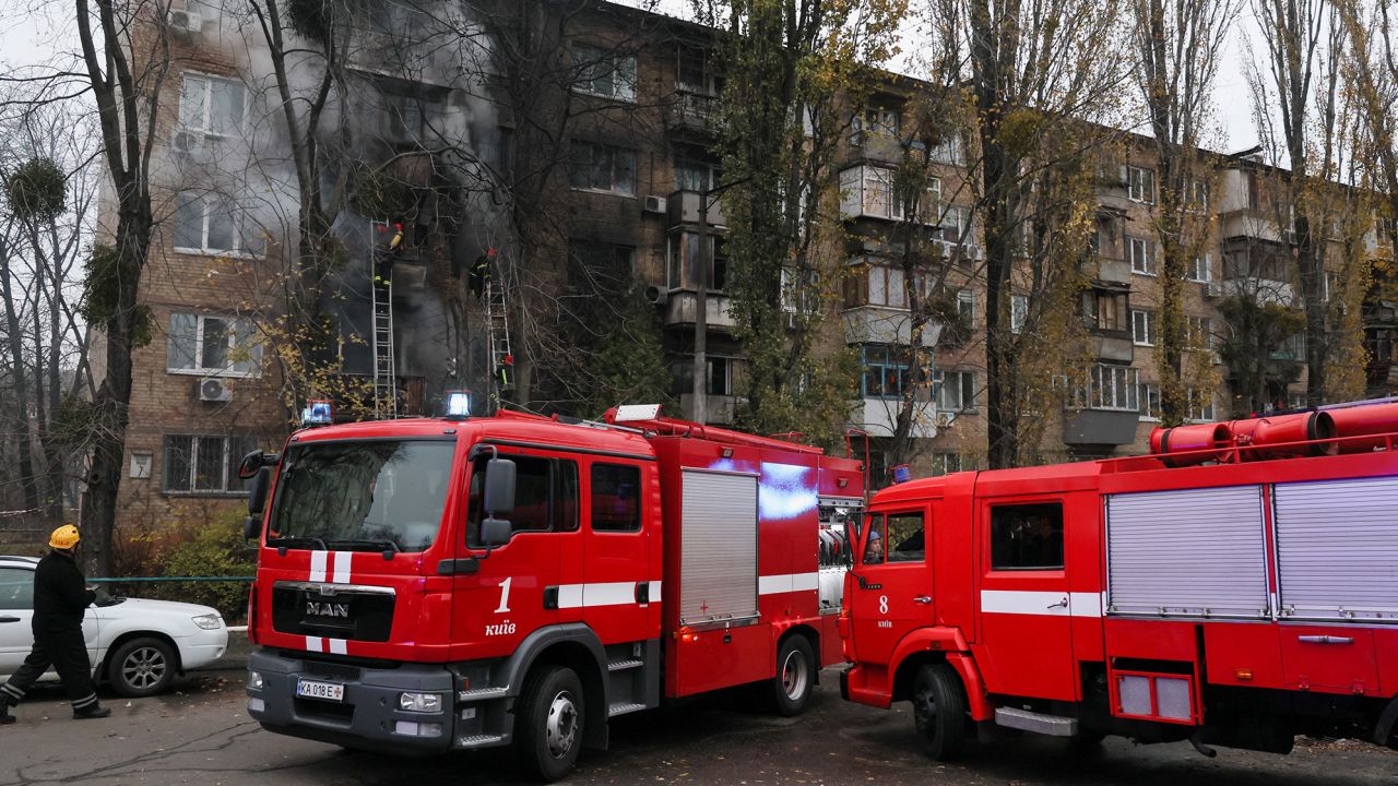 Firefighters work to put out a fire after a Russian strike hit a residential building in Kyiv on Tuesday.