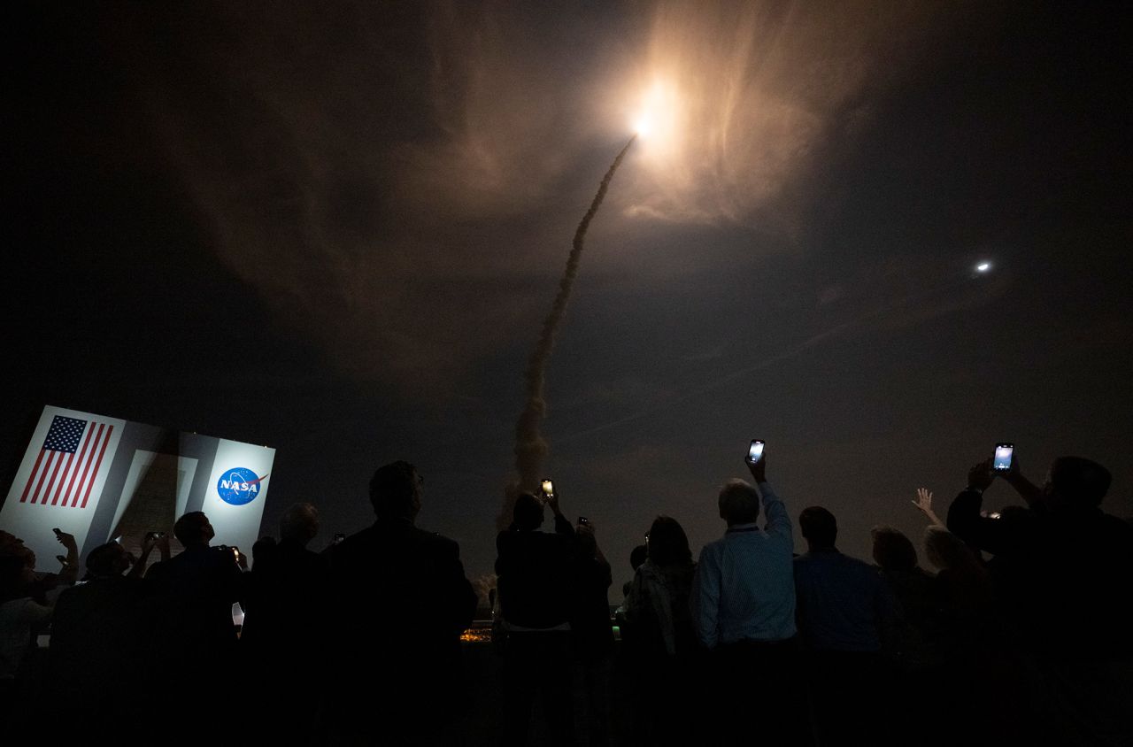Spectators watch the launch of the the Artemis I rocket.