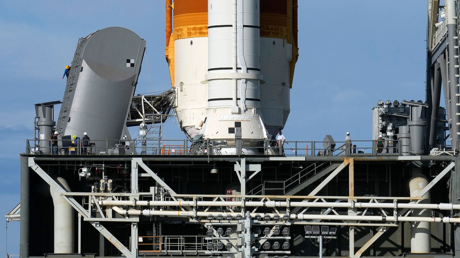 Technicians inspect the Artemis I rocket on November 13, after hurricane force winds caused minor damage.