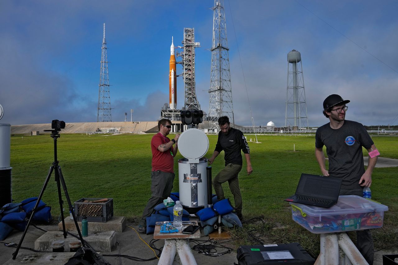 Photographers set up remote cameras in front of the launch pad on Saturday, November 12.