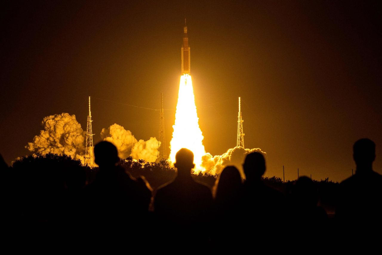 Spectators cheer as the Artemis I rocket lifts off from NASA's Kennedy Space Center in Cape Canaveral, Florida, on November 16.