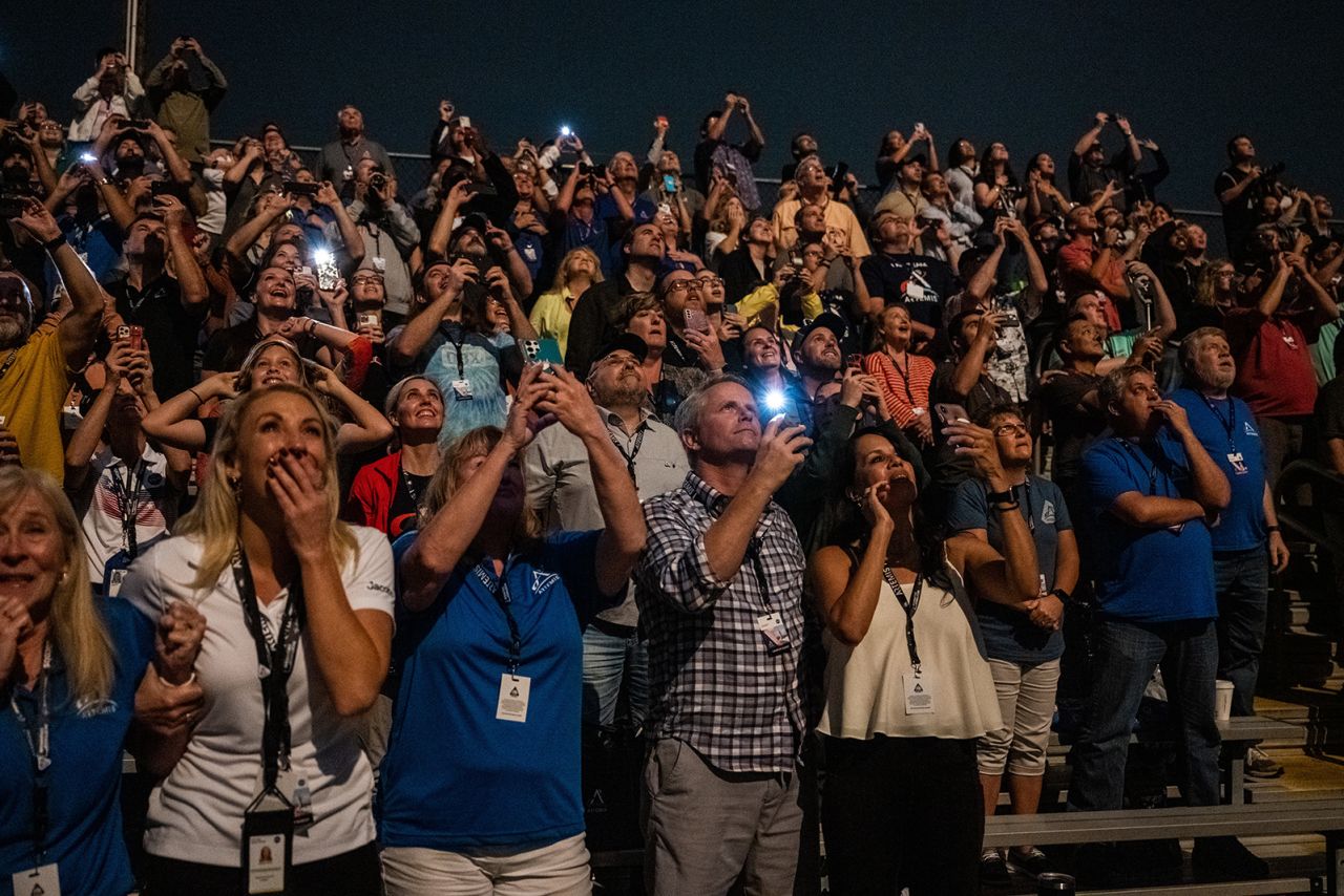 People watch the launch from the Banana Creek viewing site at Kennedy Space Center.