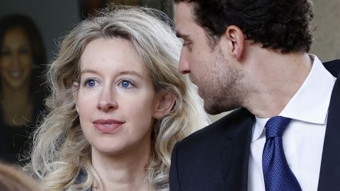 Elizabeth Holmes (L), founder of Theranos, and her partner, Billy Evans (R), leave the Robert F. Peckham Federal Building and US Courthouse in San Jose, California, on October 17, 2022.