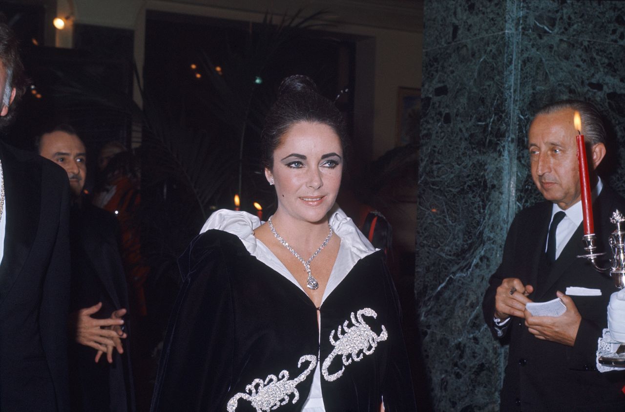 Elizabeth Taylor, a Pisces with a Scorpio husband, was admitted to the event and arrived in a velvet black cloak with Scorpio motif.
