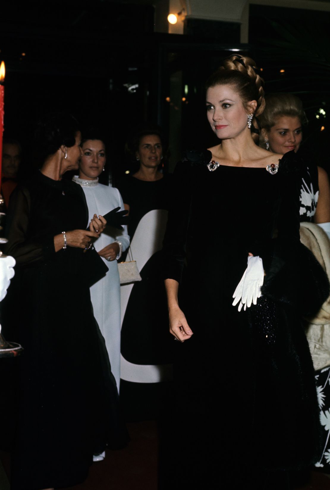 Kelly's black, velvet off-the-shoulder gown was Balenciaga couture Fall-Winter 1966, embellished with jewels from the Cartier Bains de Mer tiara.