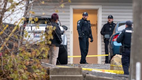 Officers investigate Sunday at the scene of the quadruple homicide at a home near the University of Idaho.