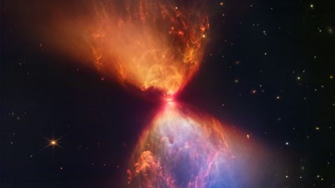 A newborn star forms the heart of a new James Webb Space Telescope image that looks like an hourglass. 
