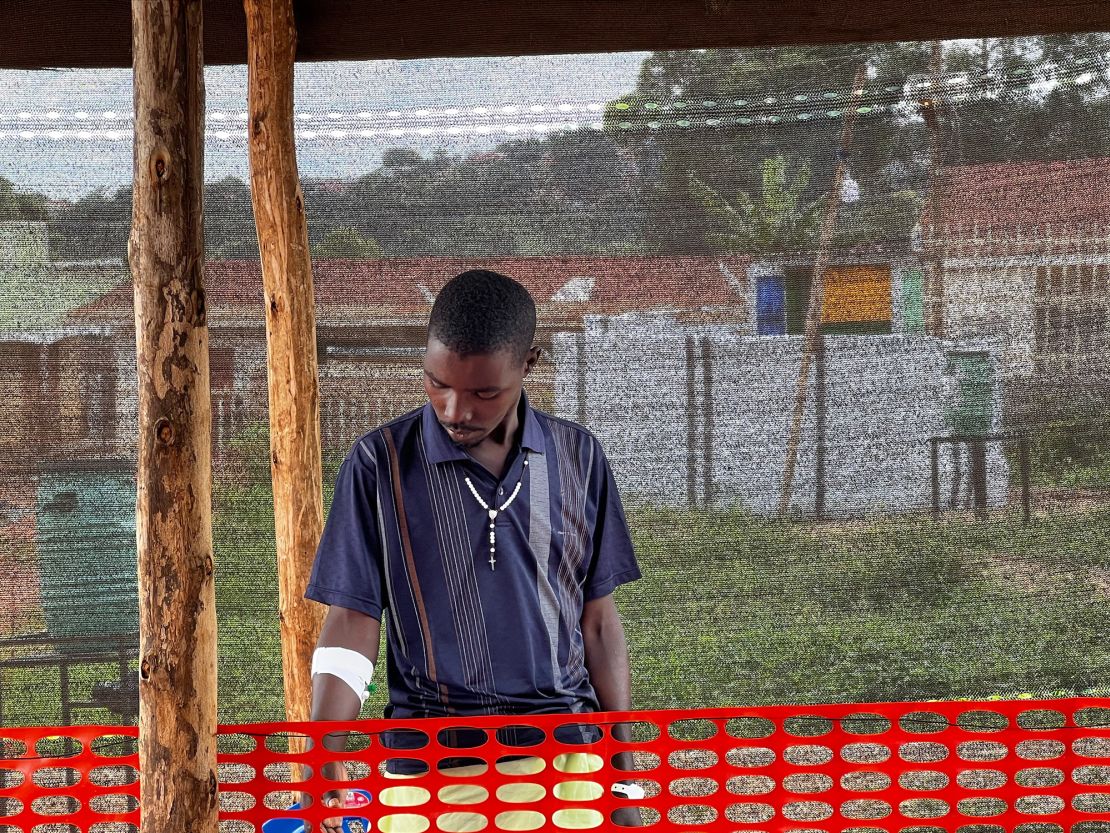 A 30-year-old driver, Robert Twinamasiko receives treatment for Ebola after helping an infected friend to an ambulance. 