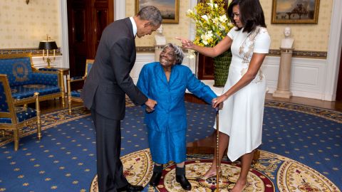 President Barack Obama and First Lady Michelle Obama greet 106-Year-Old Virginia McLaurin during a photo line in the Blue Room of the White House prior to a reception celebrating African American History Month, Feb. 18, 2016. 