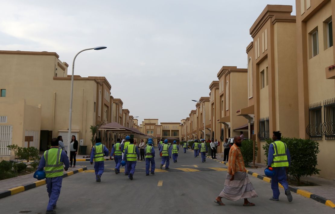 Foreign laborers working on the construction site of the Al-Wakrah football stadium, one of Qatar's 2022 World Cup stadiums, walk back to their accomodation at the Ezdan 40 compound after finishing work on May 4, 2015, in Doha's Al-Wakrah southern suburbs. 
