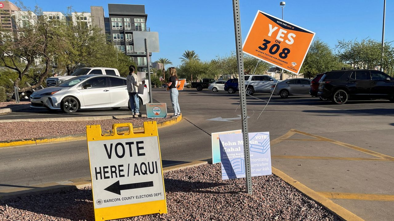 Signs to vote "Yes on 308" are seen during the 2022 US midterm elections at the Burton Barr Library in Phoenix.