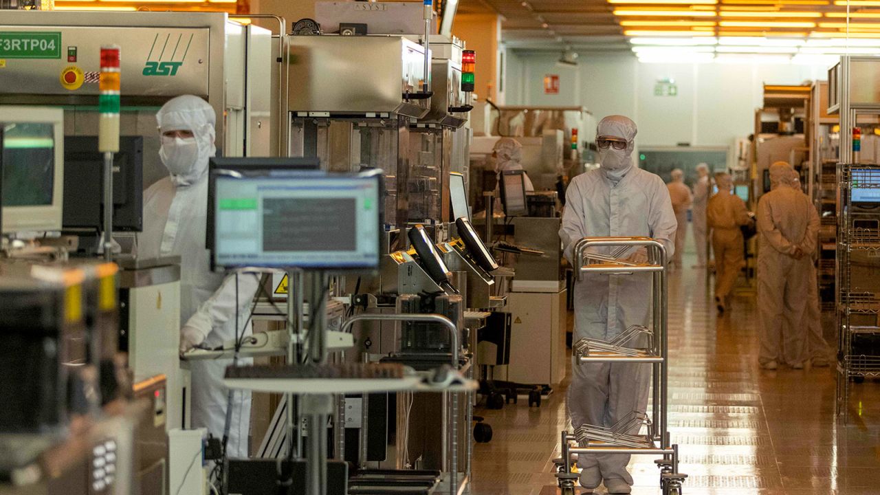 Workers in the clean room for silicon semiconductor wafer manufacturing at Newport Wafer Fab, owned by Nexperia, in Newport, UK, on Aug. 18, 2022. 
