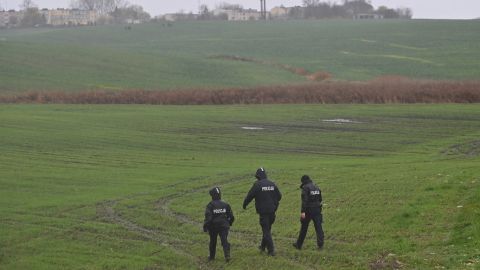 Members of the police searching the fields near the village of Przewodow, a day after two people were killed in an explosion at a farm by the Polish village. 