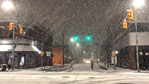Heavy snow falls Wednesday at the corner of Fourth and State Streets in Erie, Pennsylvania, as this season's first lake effect storm hits the region.