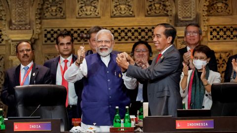 Indian Prime Minister Narendra Modi and Indonesian President Joko Widodo hold hands during the handover ceremony at the G20 leaders summit, in Nusa Dua, Bali, Indonesia, November 16, 2022. 