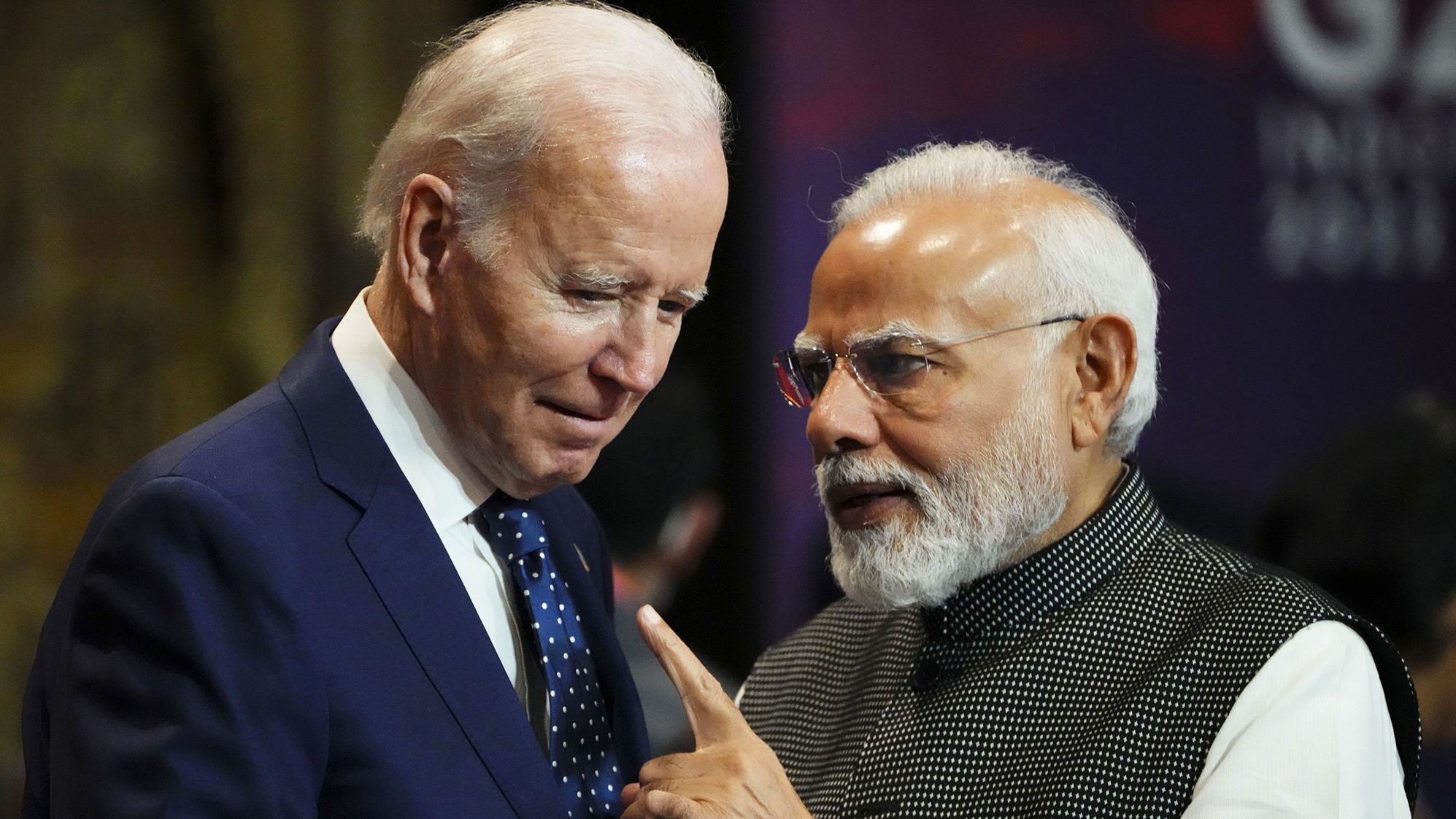 India's Prime Minister Narendra Modi talks with US President Joe Biden as they arrive for the first working session of the G20 leaders' summit in Bali on Tuesday,
