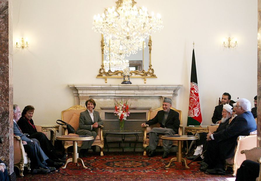 Pelosi listens to Afghan President Hamid Karzai as other delegation member looks on during a 2007 meeting at the presidential palace in Kabul, Afghanistan.
