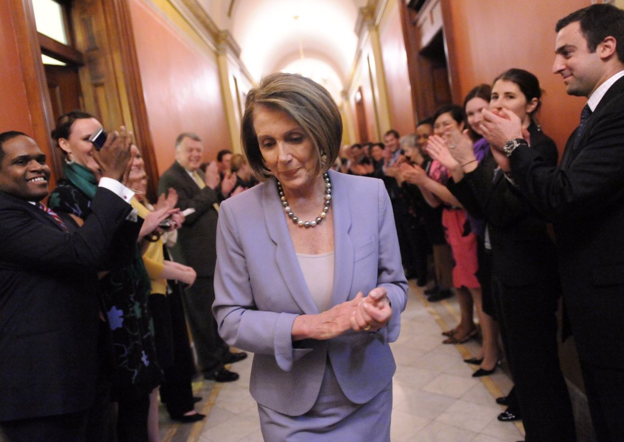 Pelosi is congratulated by her staff after the Health Care and Education Reconciliation Act of 2010 was passed by the House in 2010.