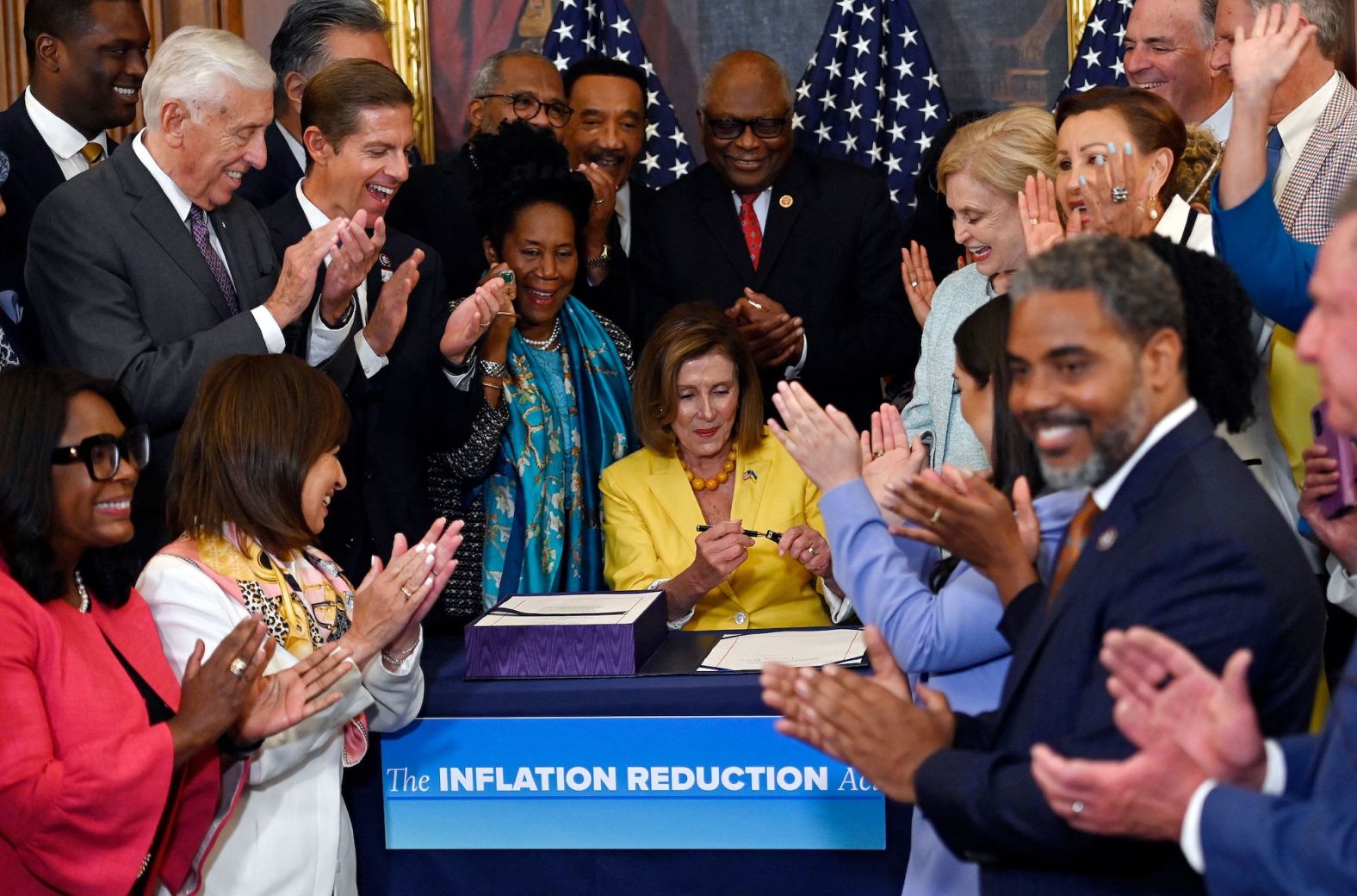 Lawmakers applaud after Pelosi signed the Inflation Reduction Act after the House of Representatives voted 220-207 to pass it in August 2022.