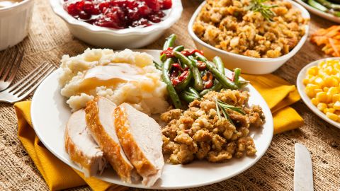 A classic Thanksgiving plate, featuring turkey, mashed potatoes, stuffing, green beans and gravy.