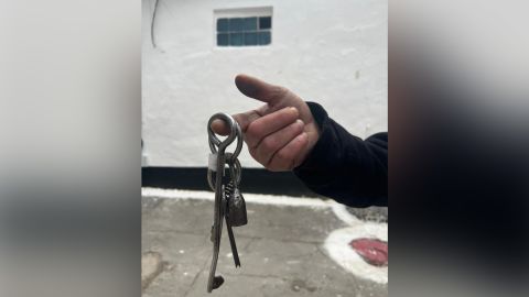 A former prisoner holds up jail keys at Kherson's central prison following the city's liberation by Ukrainian forces.