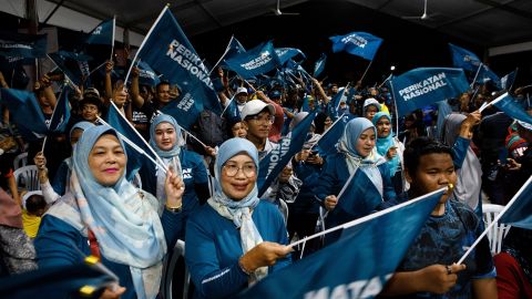 Supporters of the Perikatan Nasional party wave flags at a campaign rally in Kuala Lumpur. 