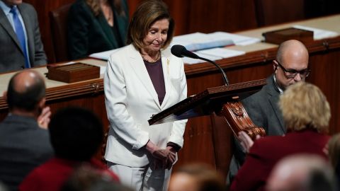 Lawmakers stand and applaud as House Speaker Nancy Pelosi pauses as she speaks on the House floor at the Capitol in Washington on November 17, 2022.